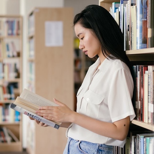 Woman reading book learn Mandarin Chinese